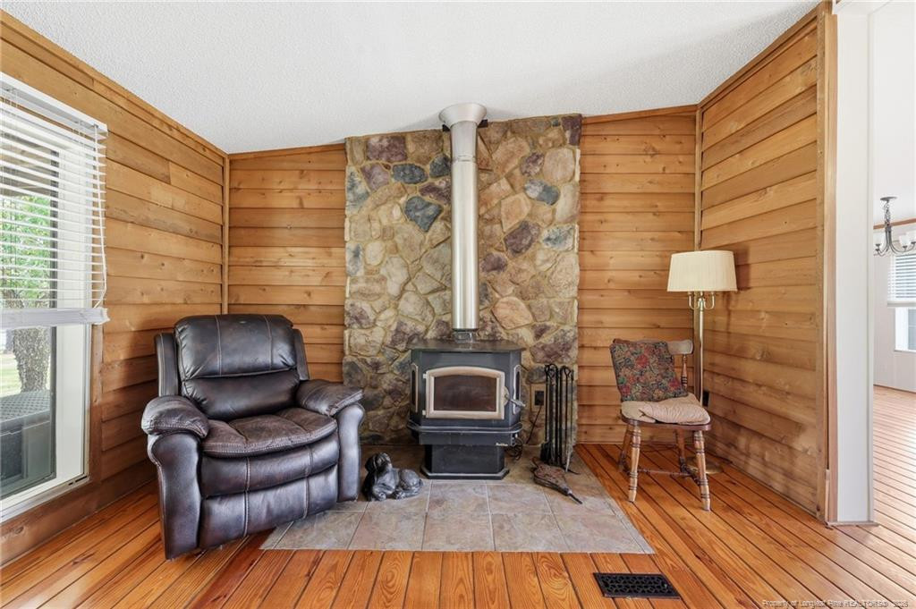 10400 Ruth Vinson Road Autryville, NC 28318 - Photo 23 of 49 a living room with furniture and a fireplace