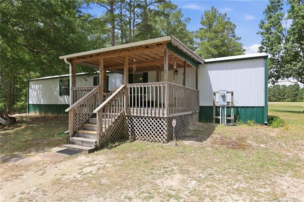 10400 Ruth Vinson Road Autryville, NC 28318 - Photo 38 of 49 a view of a house with a small yard and wooden fence