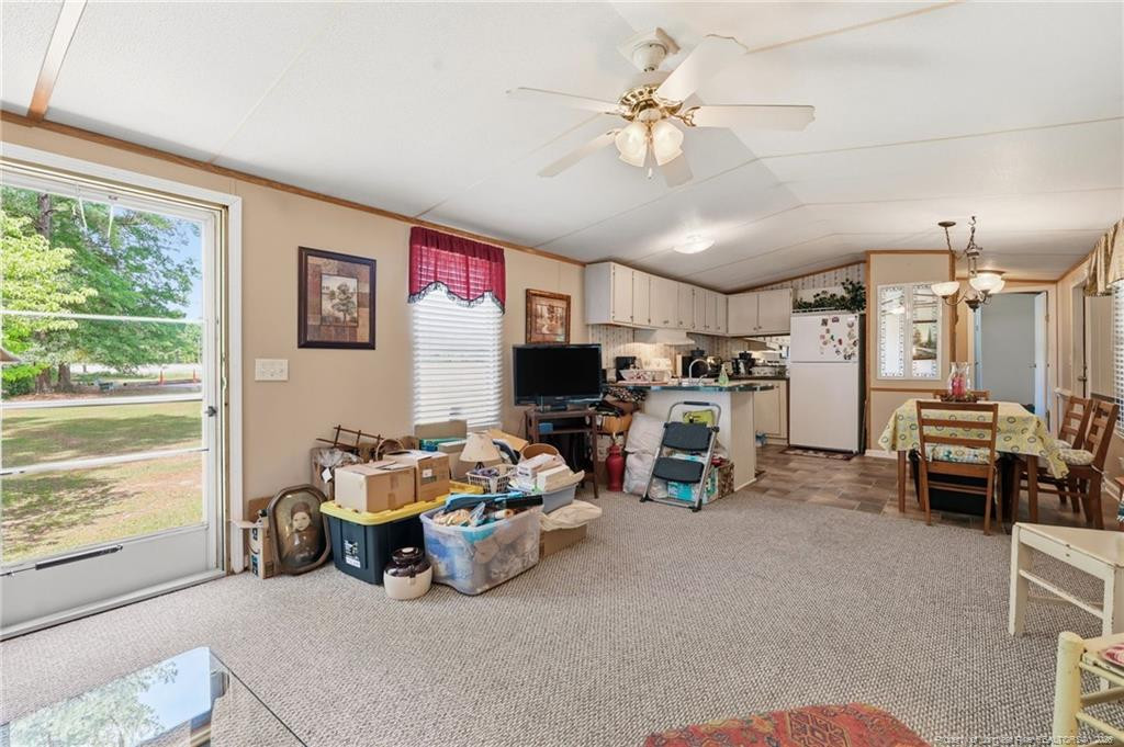 10400 Ruth Vinson Road Autryville, NC 28318 - Photo 41 of 49 a living room with furniture and a flat screen tv