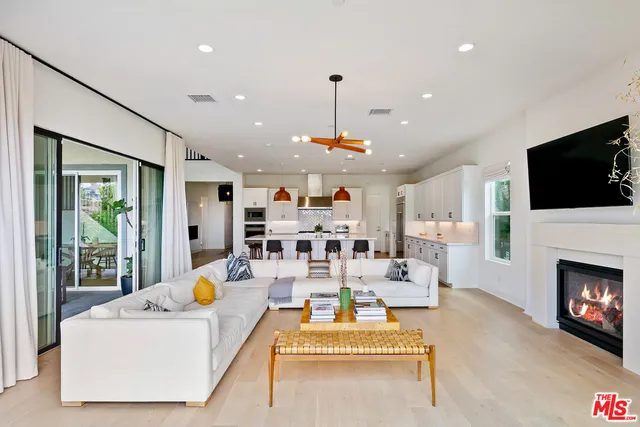 a living room with furniture fireplace and flat screen tv