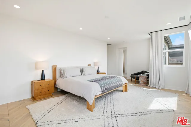 a spacious bathroom with a tub sink and mirror
