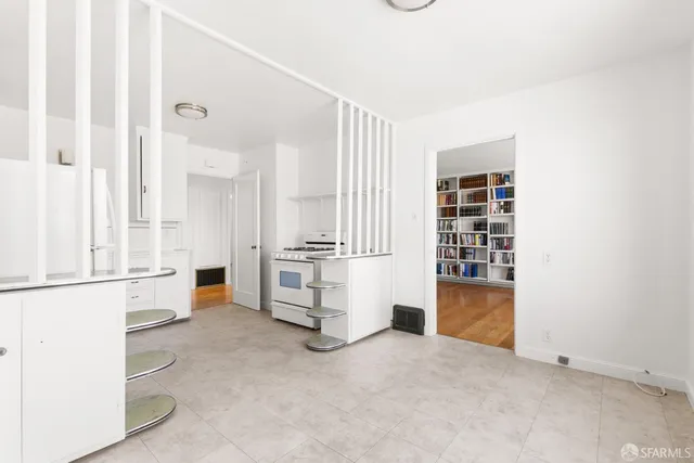 a view of kitchen with furniture and white cabinets