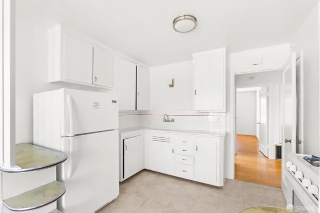 a kitchen with stainless steel appliances a refrigerator sink and cabinets
