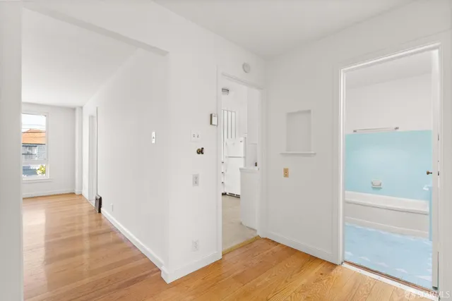 a bedroom with a bed and a potted plant