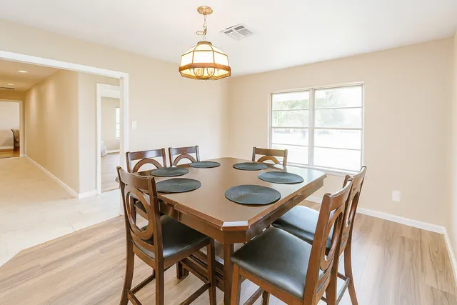 a view of a dining room with furniture and chandelier