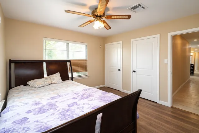 a bedroom with a bed and a chandelier