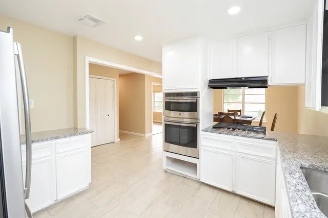 a kitchen with a stove a sink and a refrigerator