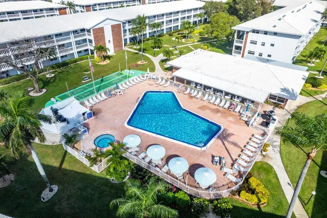 an aerial view of a city with lots of residential buildings and ocean view in back