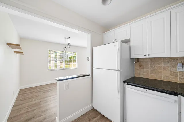 a white refrigerator freezer sitting inside of a kitchen