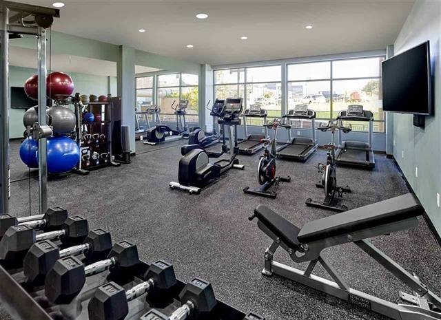 250 Ave East, Unit 609 Bayonne, NJ 07002 - Photo 11 of 17 a living room with lots of furniture and a flat screen tv