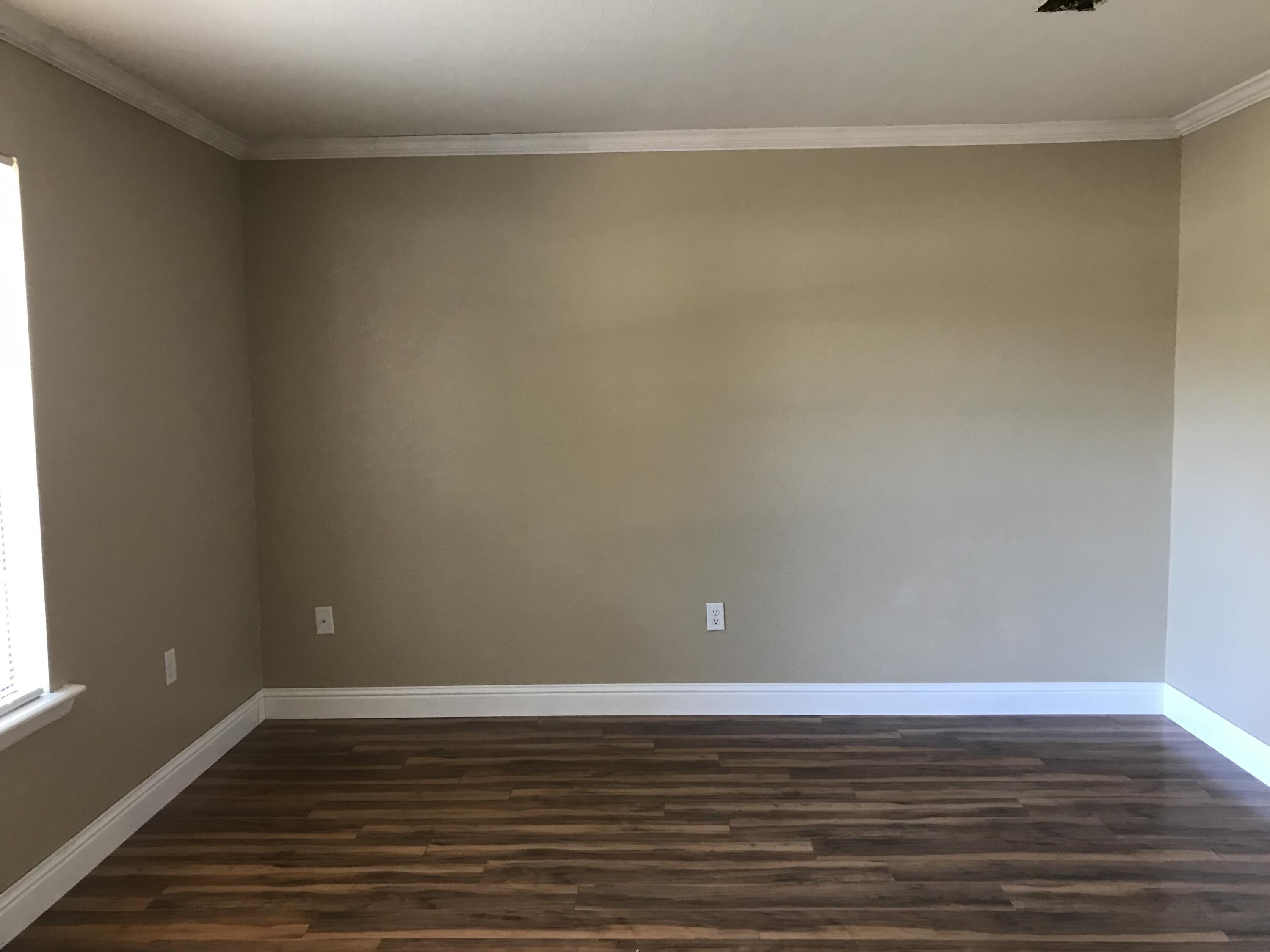 5438 Highway 4 Baker, FL 32531 - Photo 3 of 11 a view of a room with wooden floor and white walls