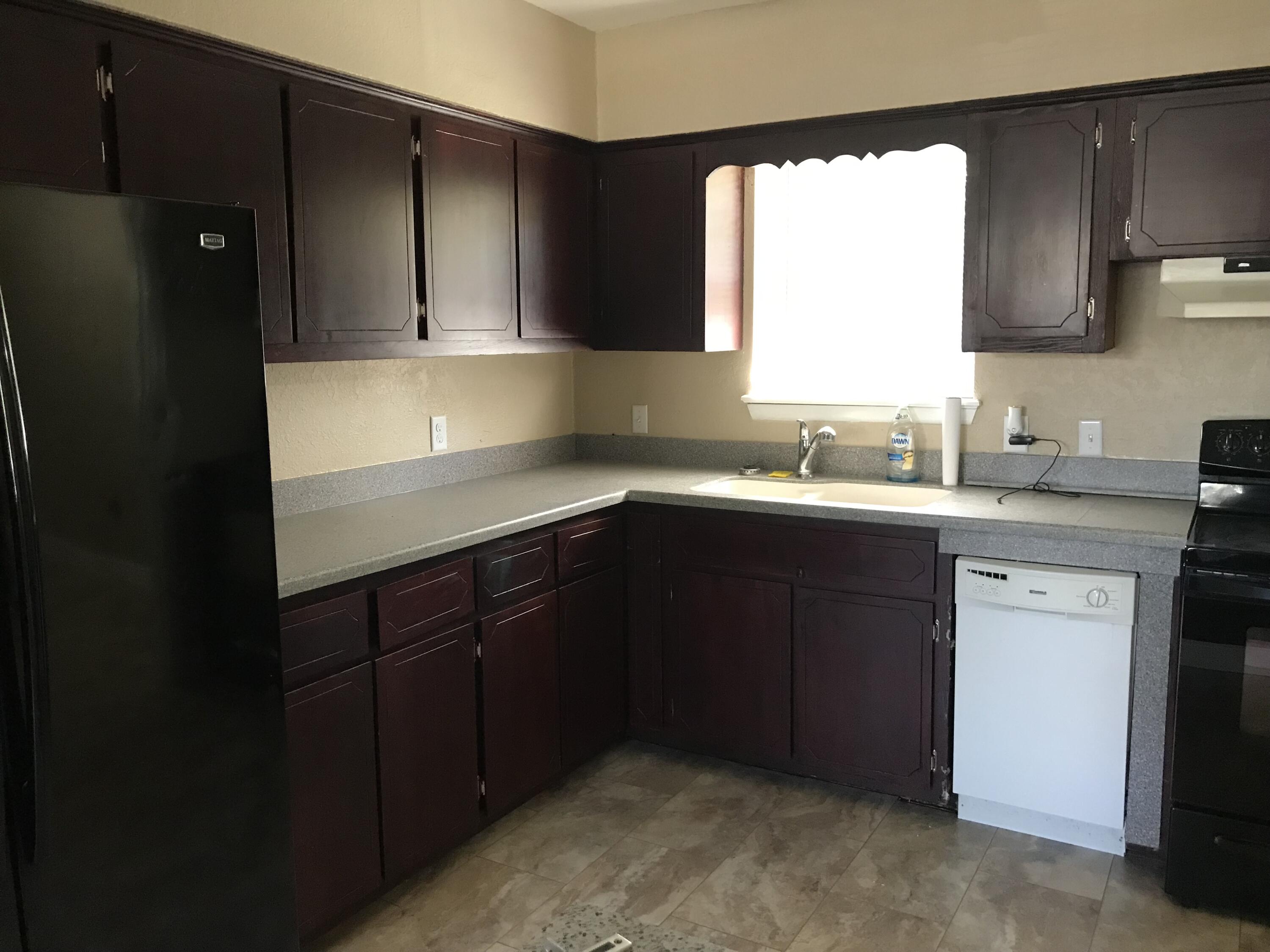 5438 Highway 4 Baker, FL 32531 - Photo 4 of 11 a kitchen with a sink a window and cabinets