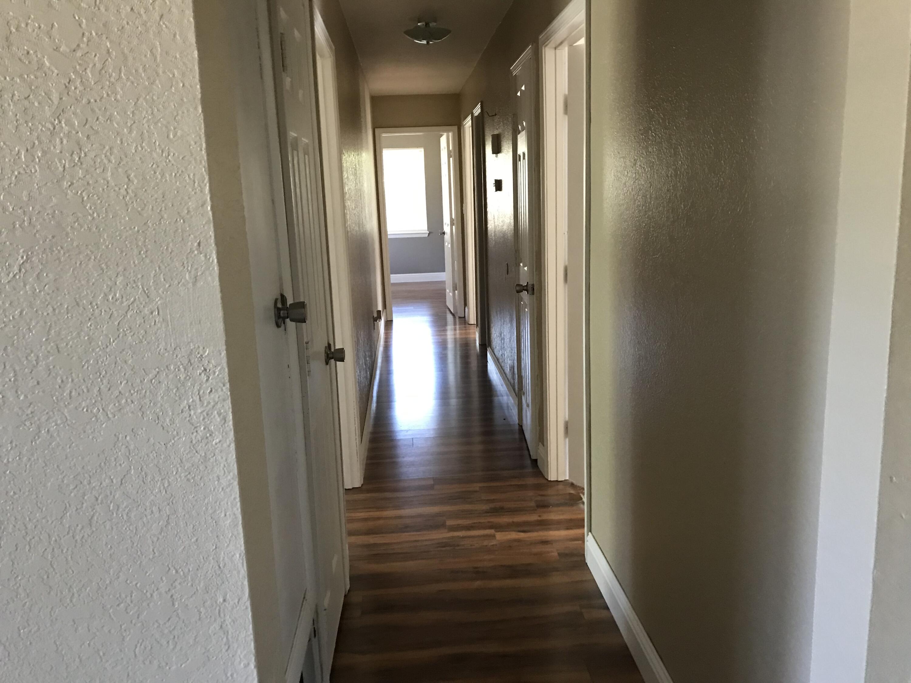 5438 Highway 4 Baker, FL 32531 - Photo 8 of 11 a view of a hallway with wooden floor and staircase