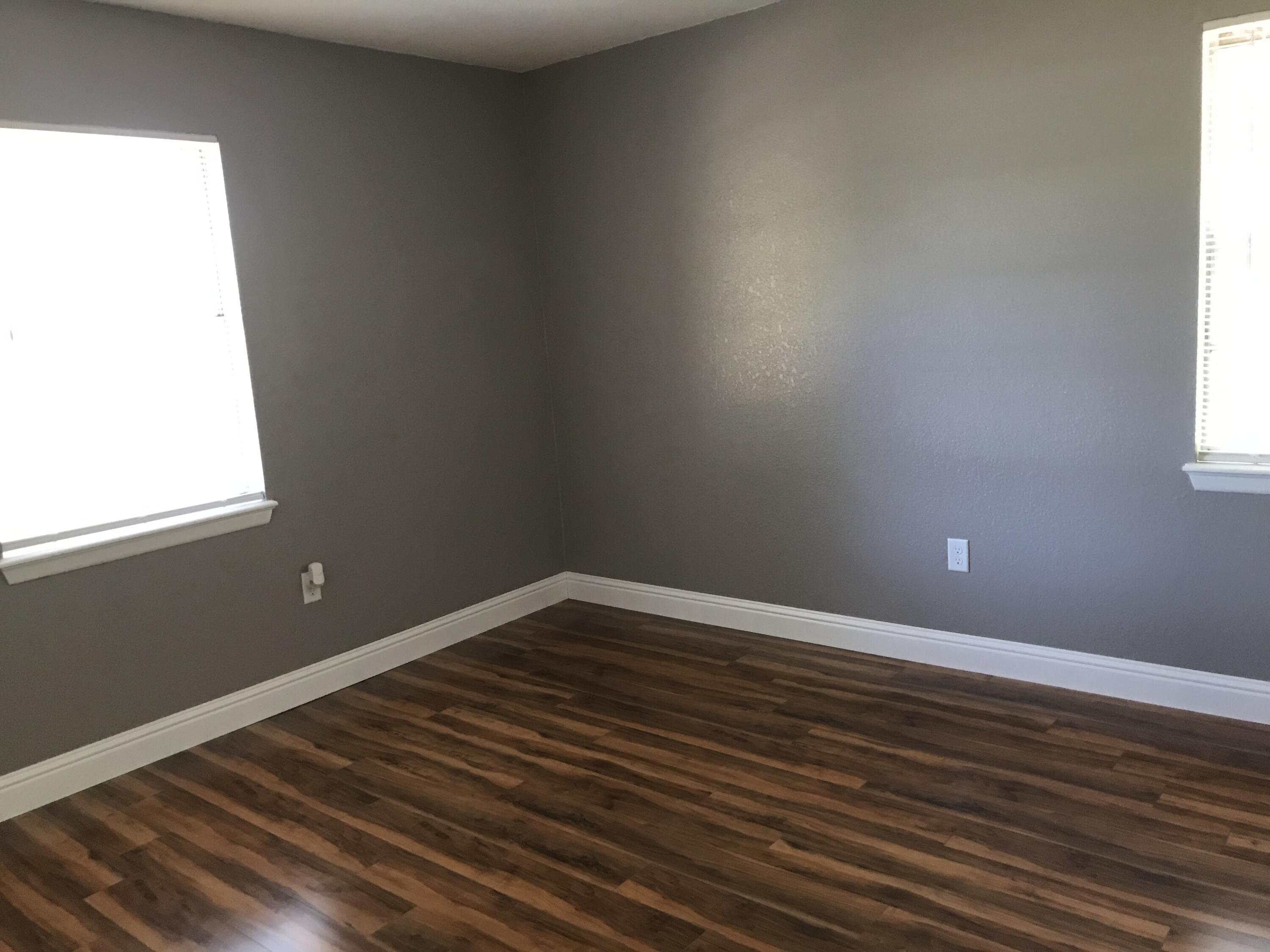 5438 Highway 4 Baker, FL 32531 - Photo 9 of 11 a view of an empty room with wooden floor and a window