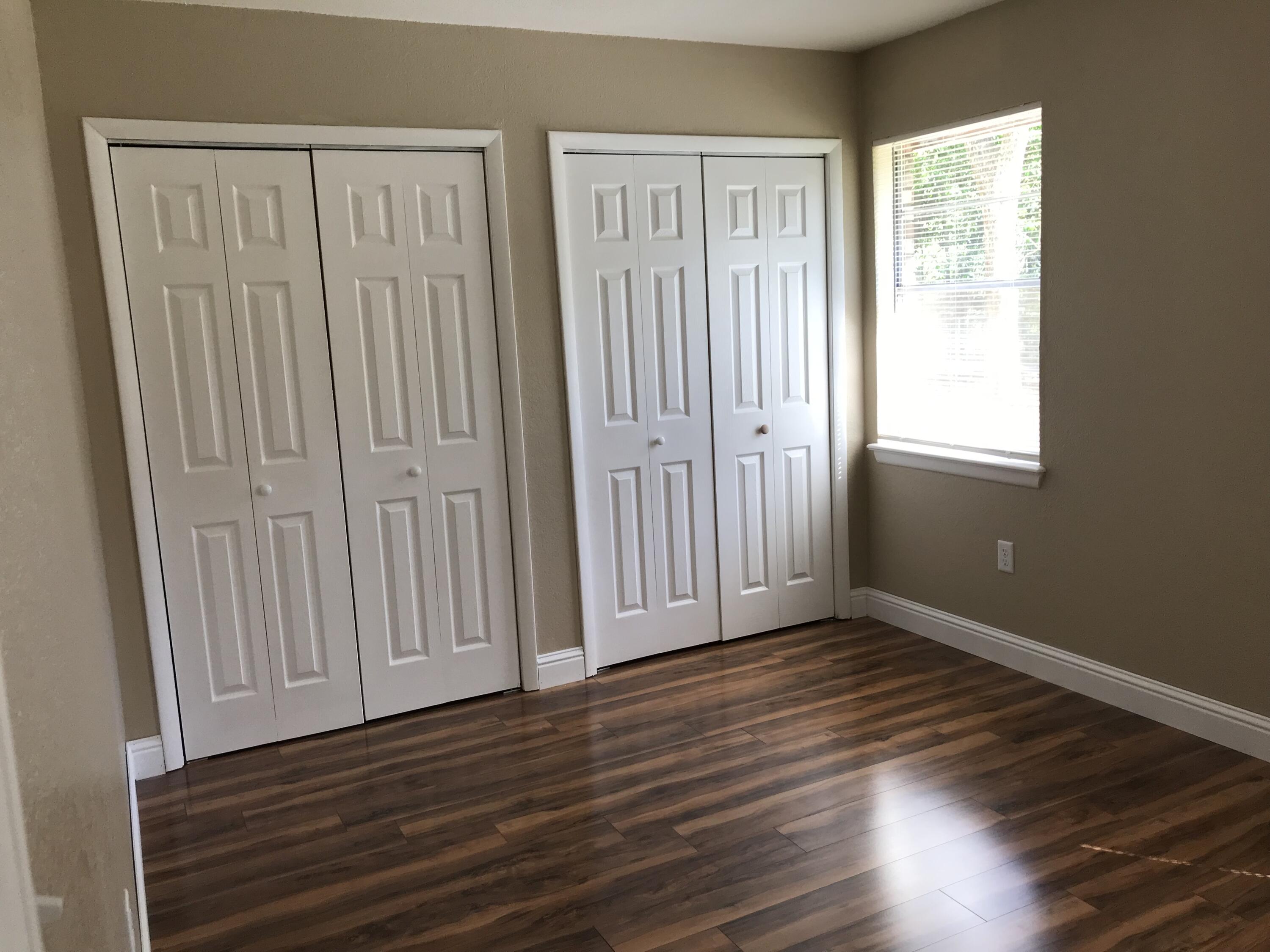 5438 Highway 4 Baker, FL 32531 - Photo 10 of 11 a view of an empty room with wooden floor and a window