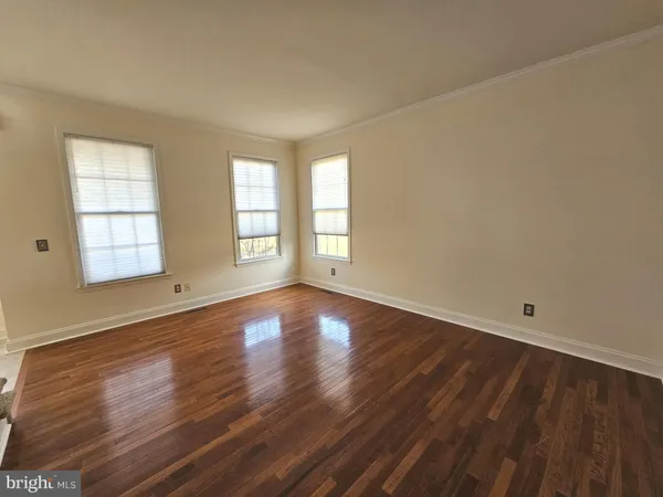 a view of a room with wooden floor window and a ceiling fan