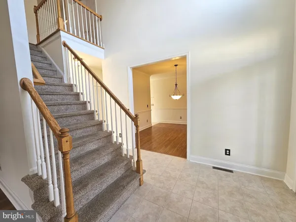 a view of a room with wooden floor and white walls