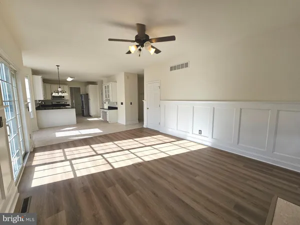 a kitchen with granite countertop a stove a sink a refrigerator and a cabinets