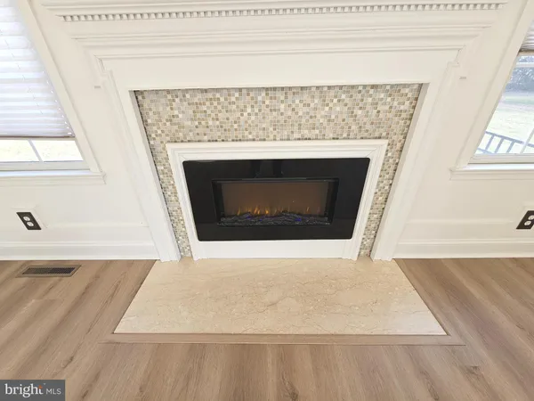a kitchen with granite countertop a refrigerator sink and cabinets