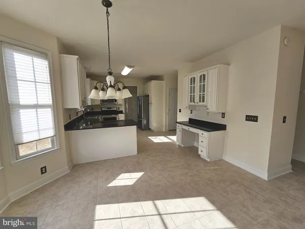 a kitchen with stainless steel appliances granite countertop a refrigerator and a stove