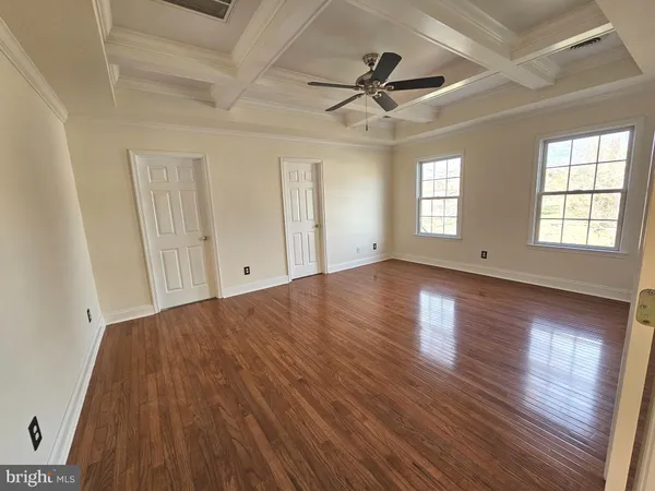 a view of hallway with stairs and wooden floor