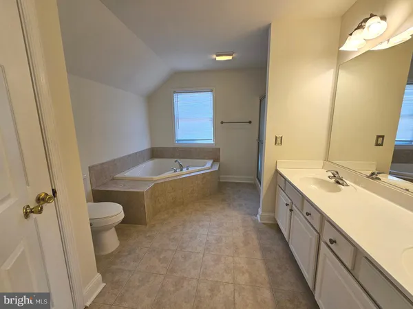 a view of an empty room and wooden floor