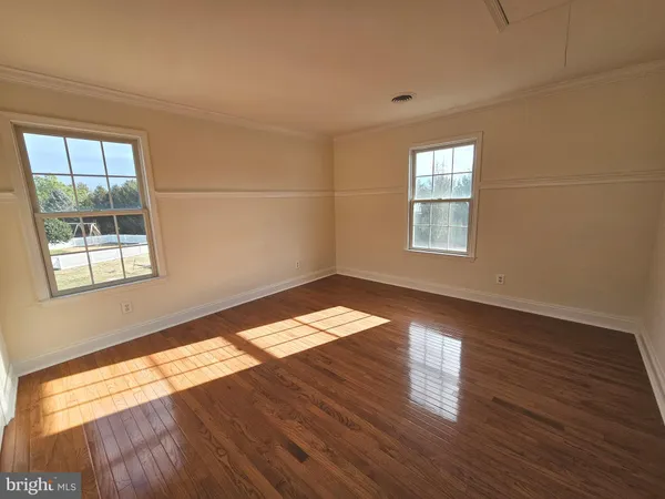 a view of an empty room and wooden floor