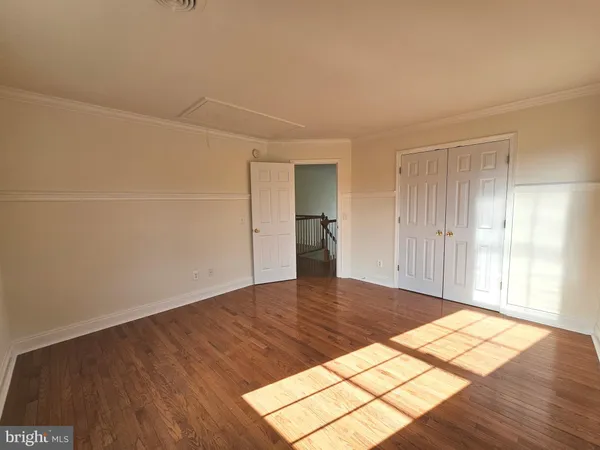 a view of a room with wooden floor