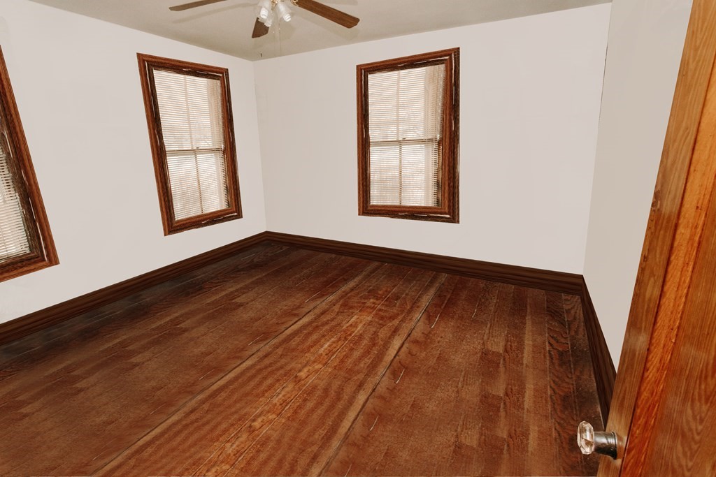 452 Gallivan Boulevard Boston, MA 02124 - Photo 19 of 24 a view of an empty room with wooden floor and a window