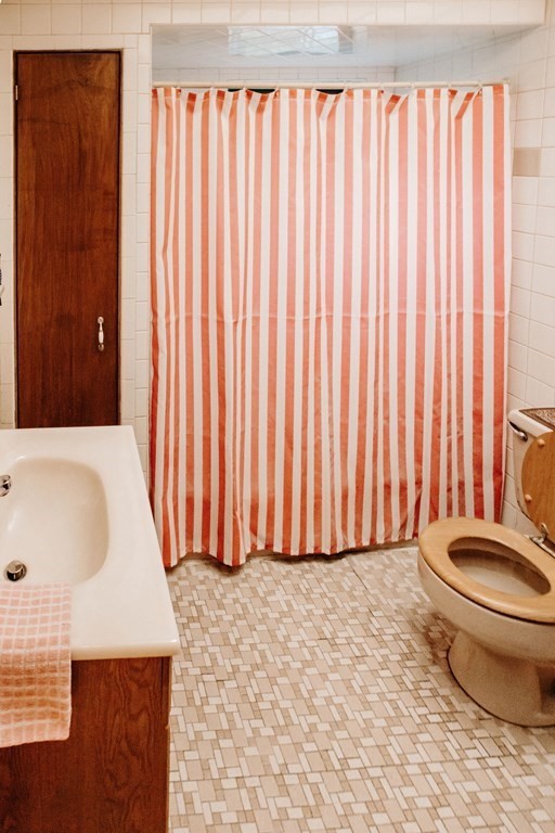 452 Gallivan Boulevard Boston, MA 02124 - Photo 9 of 24 a bathroom with a sink a toilet and tub