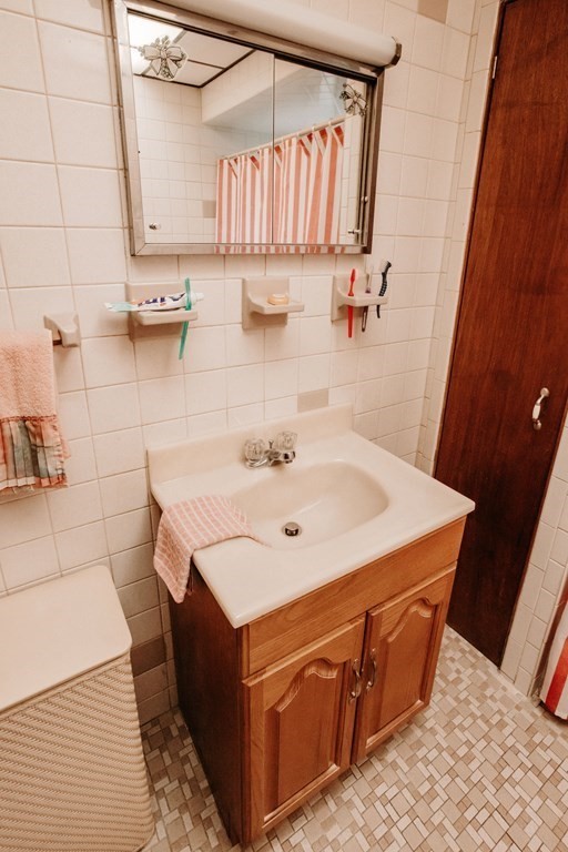 452 Gallivan Boulevard Boston, MA 02124 - Photo 10 of 24 a bathroom with a sink and a mirror
