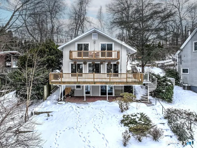 a view of a house with a yard covered in snow