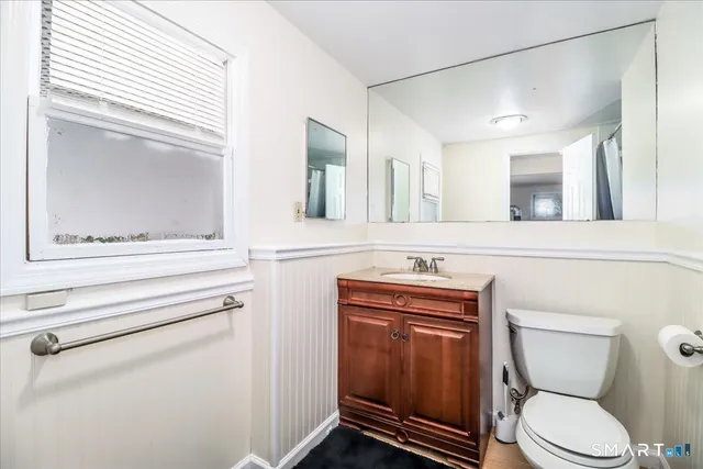 a bathroom with a sink a toilet and mirror