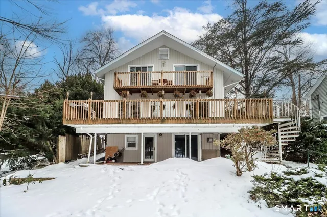 a view of a house with a wooden floor and a yard