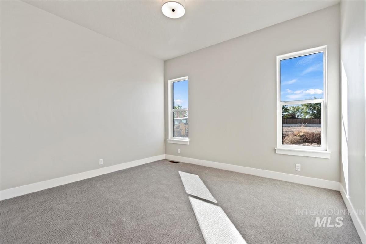 7353 Powell Place Eagle, ID 83714 - Photo 30 of 45 Carpeted empty room with plenty of natural light