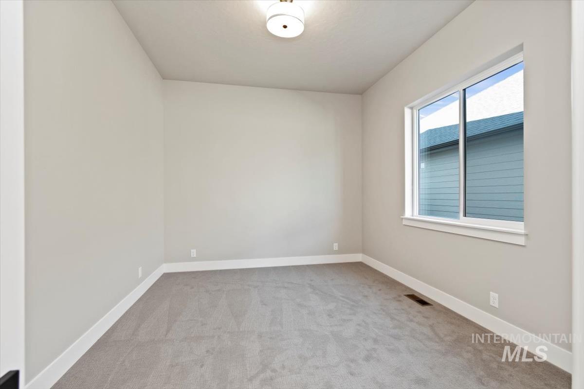 7353 Powell Place Eagle, ID 83714 - Photo 35 of 45 Empty room featuring light colored carpet and baseboards