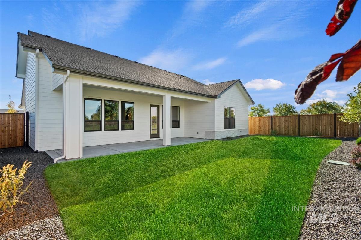 7353 Powell Place Eagle, ID 83714 - Photo 41 of 45 Rear view of property featuring a fenced backyard, a shingled roof, and a patio