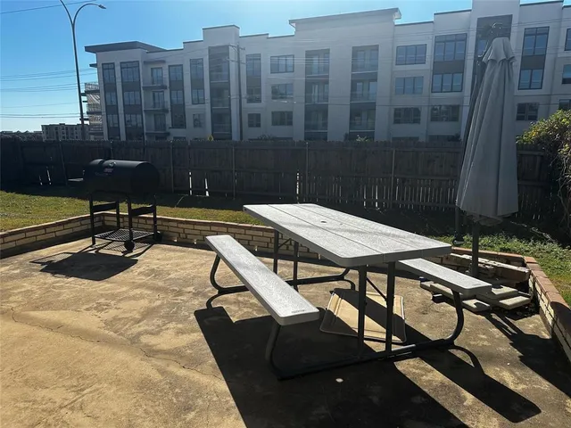 a view of a patio with chairs and table
