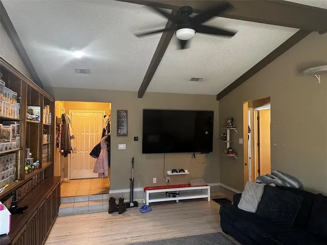 a view of a livingroom with furniture and a flat screen tv