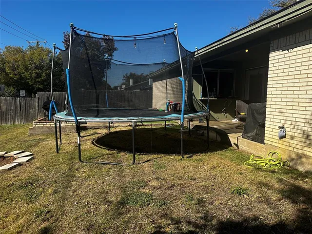 a swimming pool with outdoor seating and yard