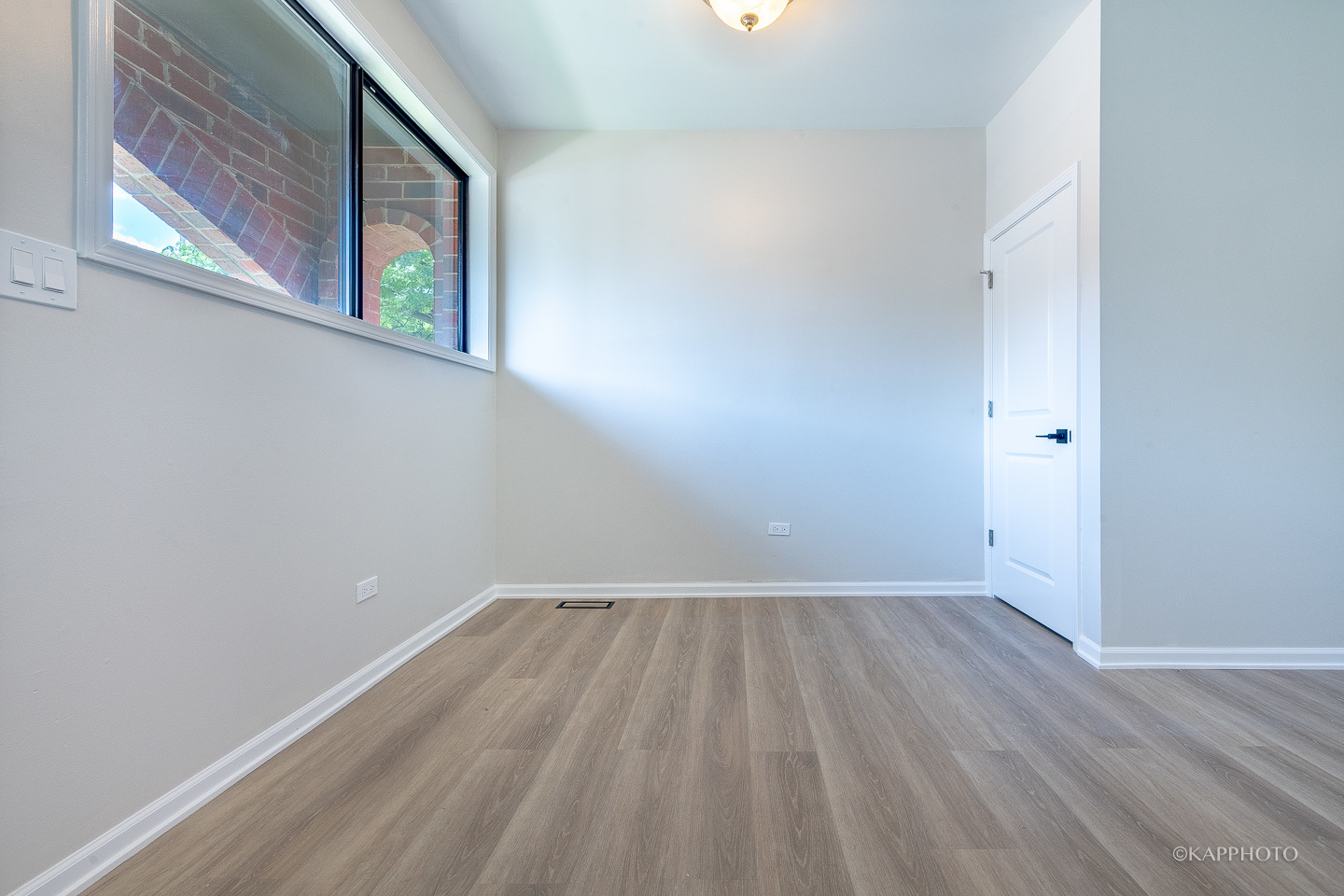 901 South Racine Avenue, Unit C Chicago, IL 60607 - Photo 3 of 39 a view of an empty room with wooden floor and a window