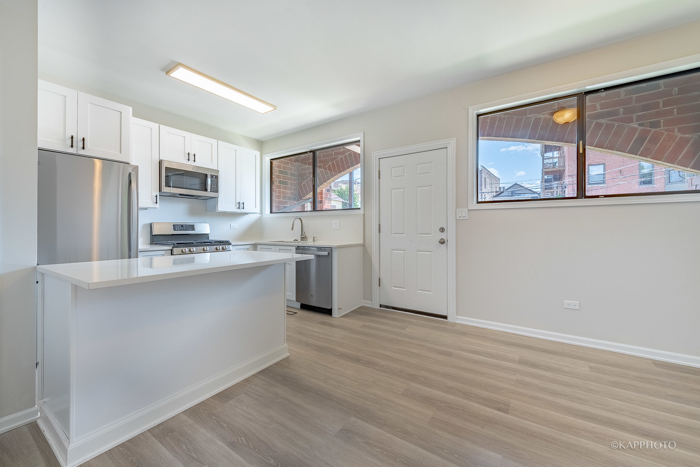 901 South Racine Avenue, Unit C Chicago, IL 60607 - Photo 7 of 39 a kitchen with stainless steel appliances a refrigerator and a stove top oven