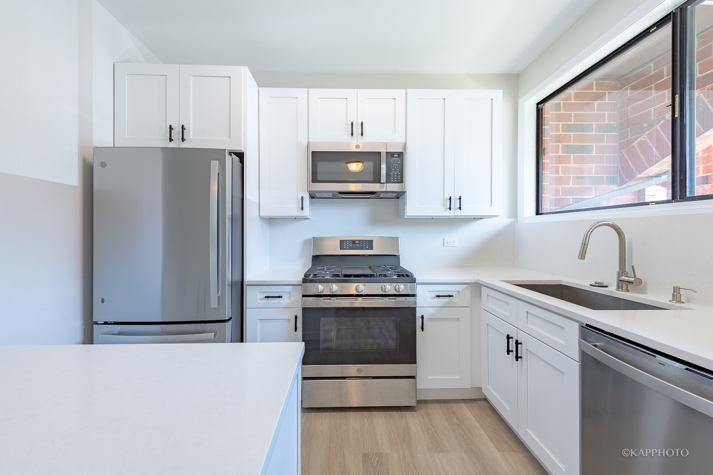 901 South Racine Avenue, Unit C Chicago, IL 60607 - Photo 8 of 39 a kitchen with stainless steel appliances granite countertop a stove a sink and a refrigerator with wooden floors