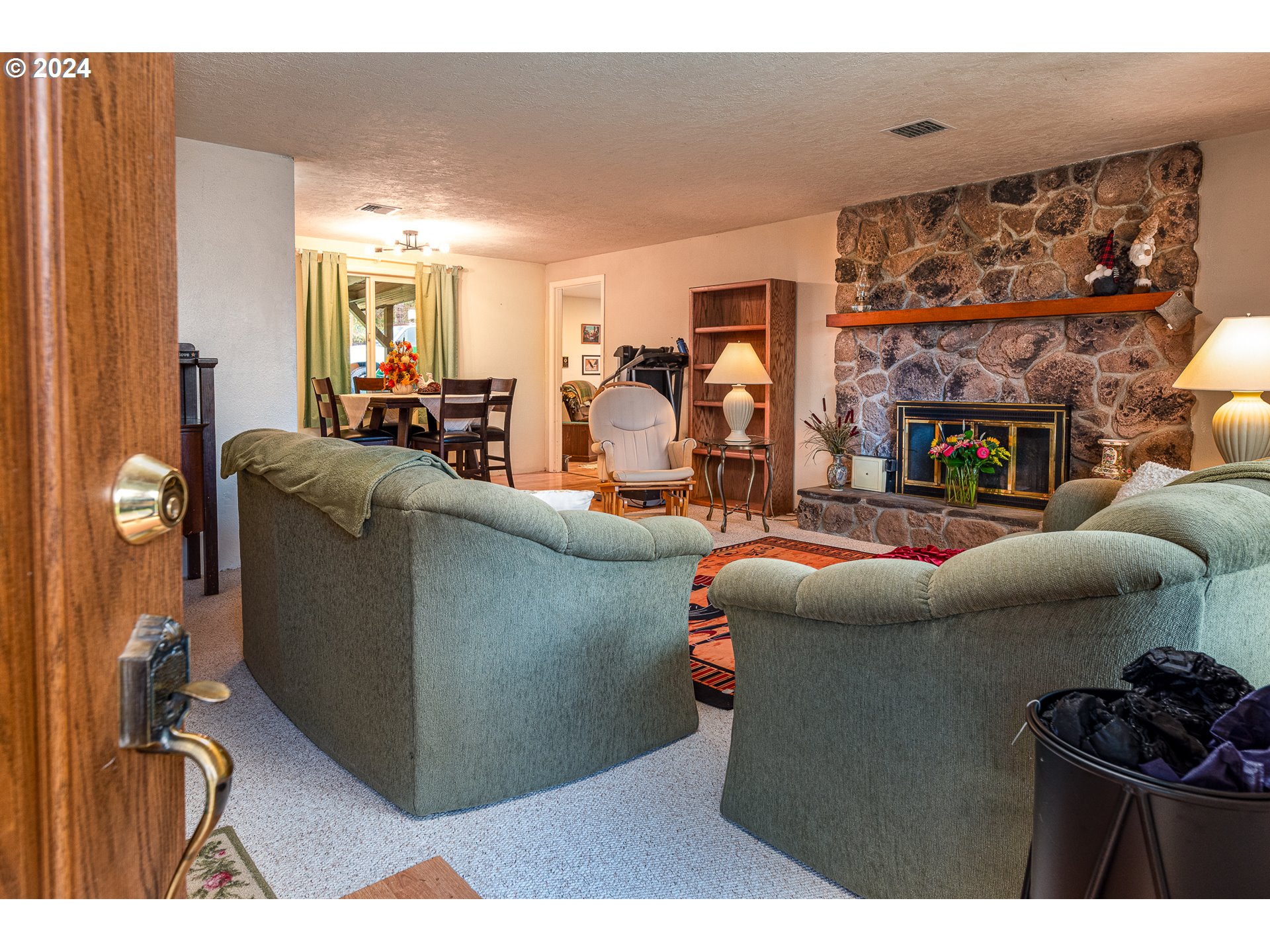 28383 Pleasant Valley Road Sweet Home, OR 97386 - Photo 8 of 34 a living room with furniture a flat screen tv and a floor to ceiling window