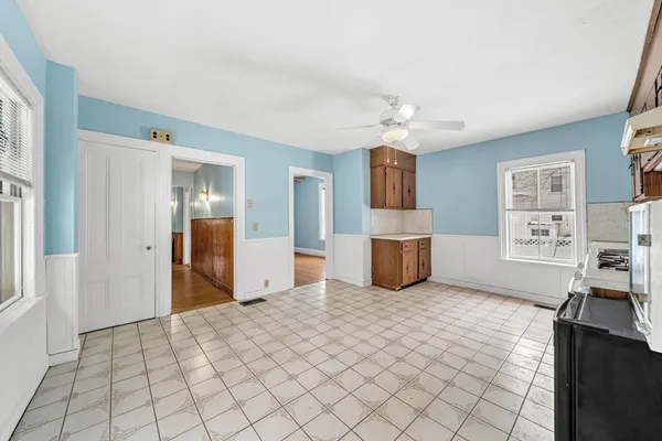 a view of a kitchen with furniture and wooden floor