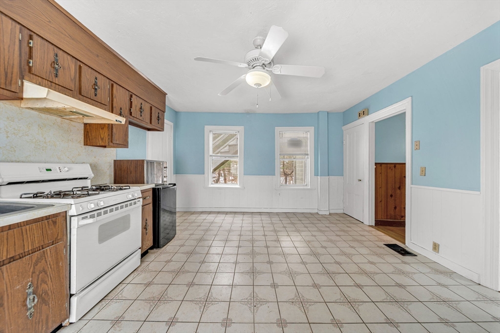28 Linden Place Dedham, MA 02026 - Photo 18 of 42 a kitchen with a stove a sink and a refrigerator