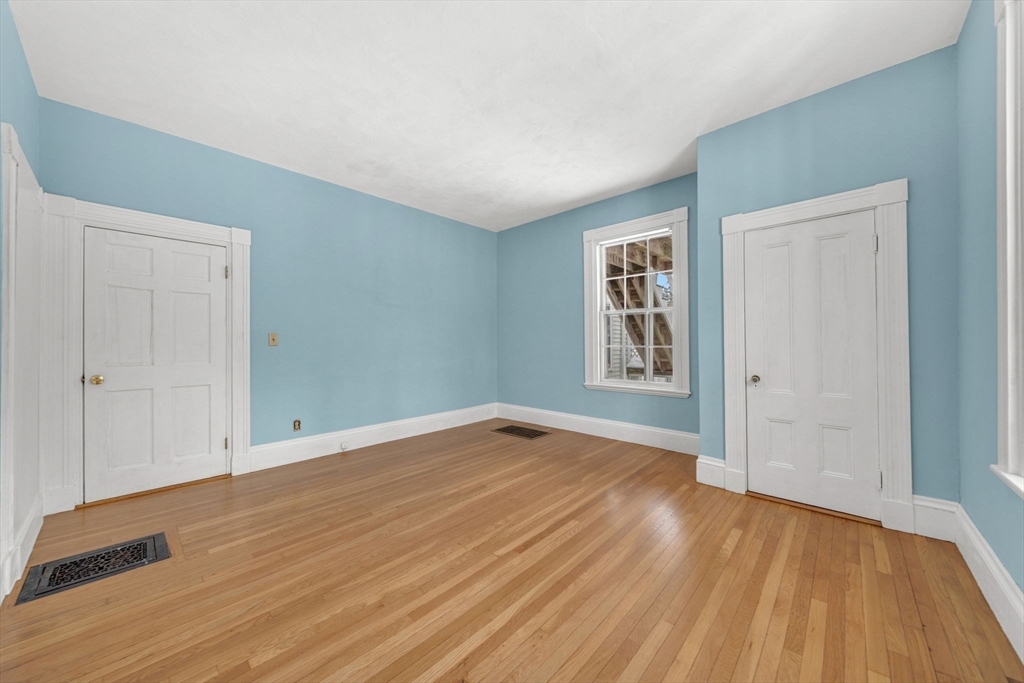 28 Linden Place Dedham, MA 02026 - Photo 21 of 42 a view of an empty room with wooden floor and a window