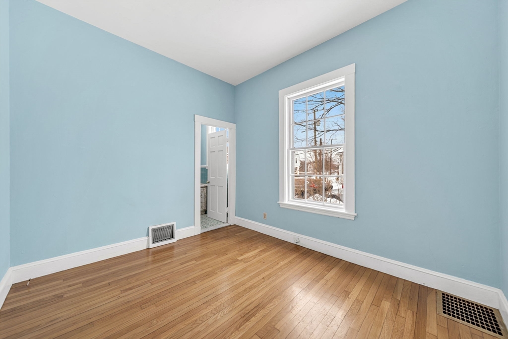 28 Linden Place Dedham, MA 02026 - Photo 22 of 42 a view of an empty room with wooden floor and a window