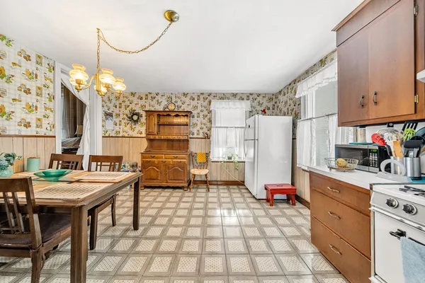 a kitchen with refrigerator and cabinets