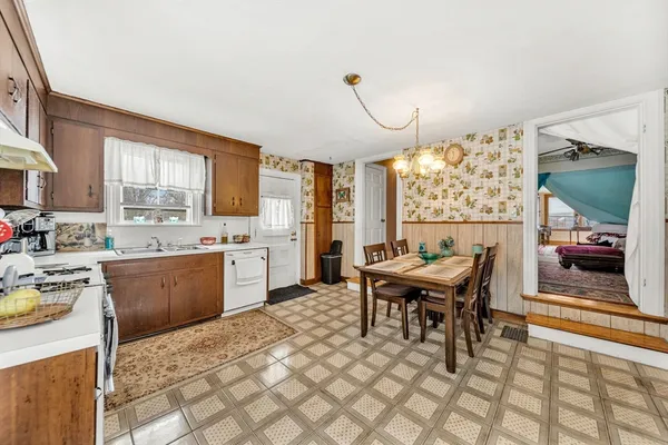 a kitchen with a table chairs sink and cabinets